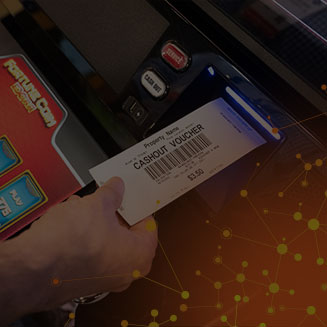 A person taking their cash out  voucher from a gaming terminal using IGT EZ Pay